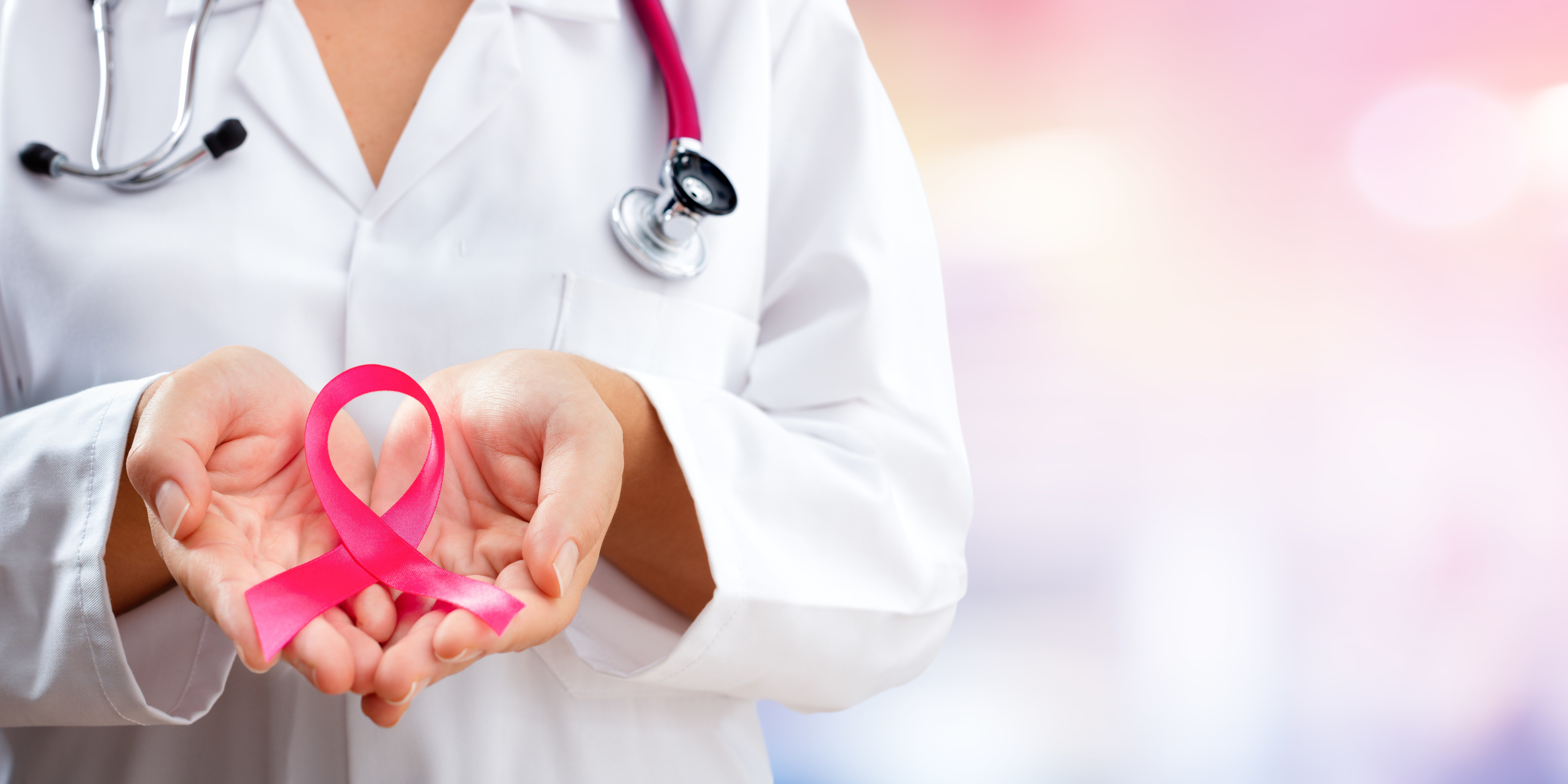 doctor-hands-holding-pink-cancer-awareness-ribbon